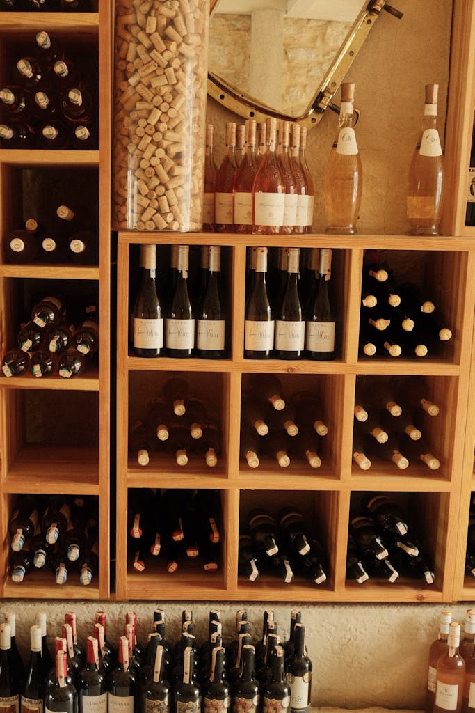 Assorted wine bottles in a wooden rack, showcasing wine cellar elegance and organization.