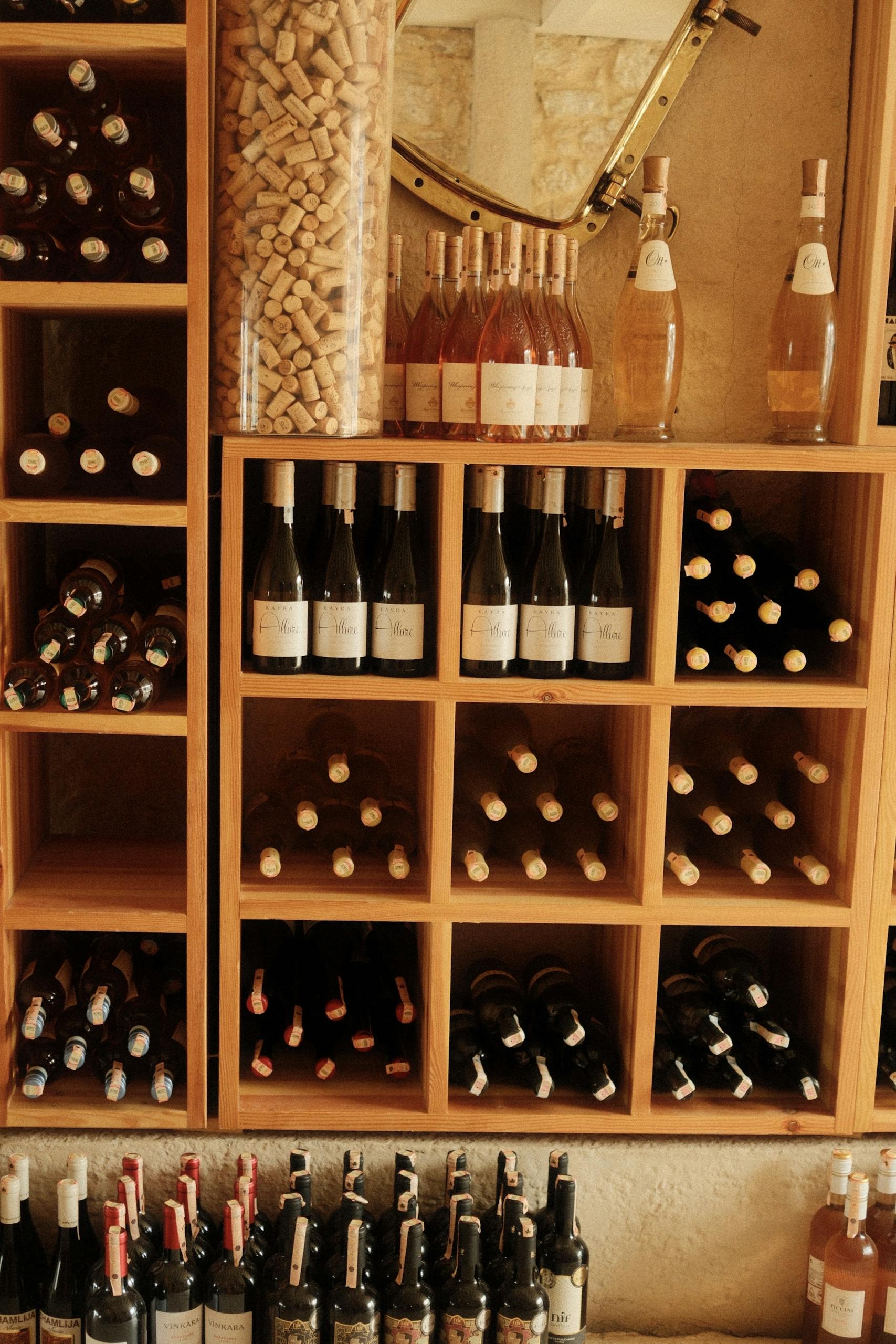 Assorted wine bottles in a wooden rack, showcasing wine cellar elegance and organization.